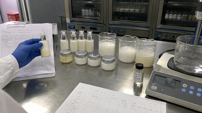Laboratory bench with stability test samples and batch documentation, iPhone-angle snapshot