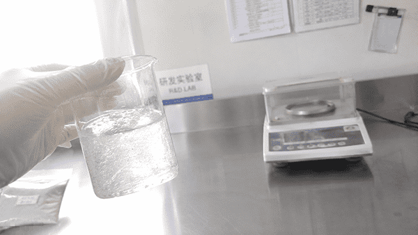 Beta-Glucan Serum OEM Manufacturing A laboratory technician examining a beaker of beta-glucan serum in a GMP-certified facility