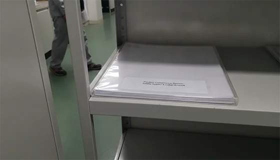 A visual of a "Compliance Dossier" folder containing icons for a safety report, facility registration, product listing, and label artwork.