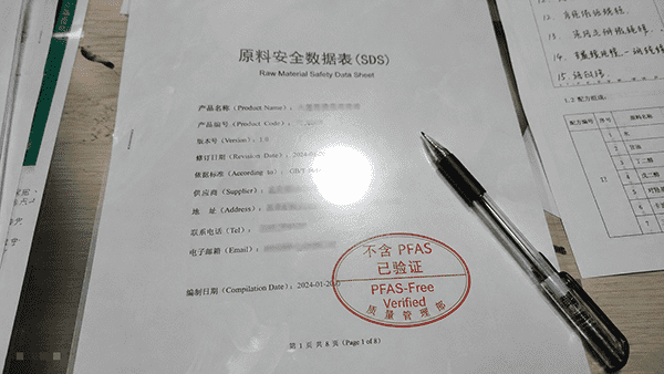 A close-up shot of a signed compliance document with a pen lying on top