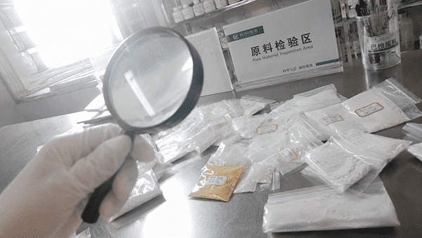 A lab technician carefully inspecting cosmetic ingredients under a magnifying glass