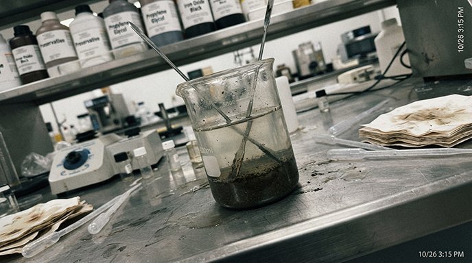 A cosmetic chemist working on a formula in a lab