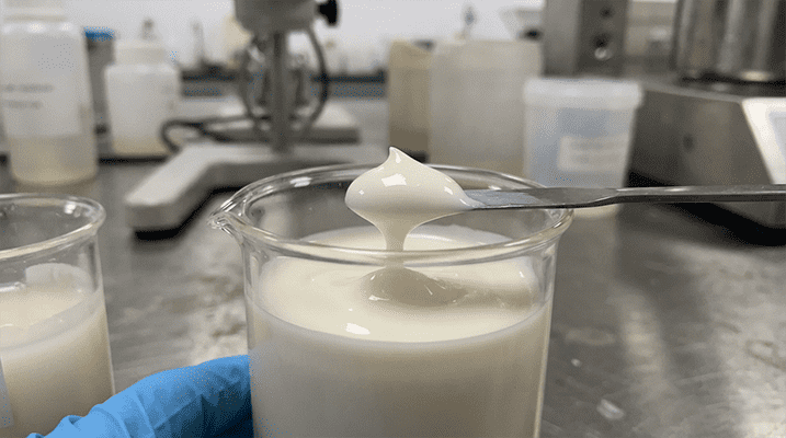 A close-up of a stable cosmetic cream's texture, a key outcome of expert cosmetic formulation design.