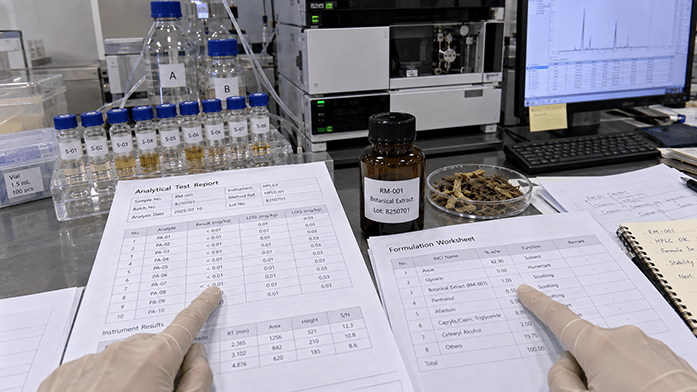Alkaloid test report and HPLC sample vials beside a formulation worksheet on an analytical bench
